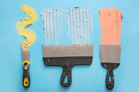 Putty knives on blue backgroundの写真素材