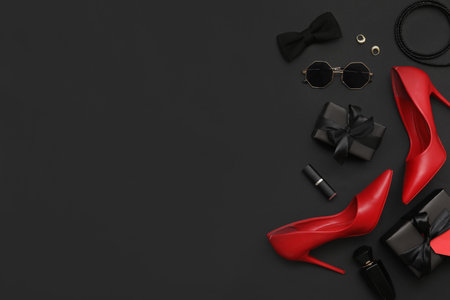 Composition with stylish high-heeled shoes, accessories and gifts on dark background. Black Friday saleの写真素材