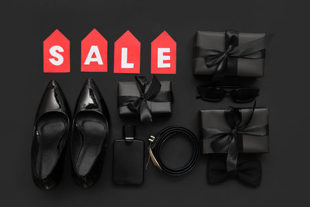 Composition with the word SALE, gifts, stylish female shoes and accessories on dark backgroundの写真素材