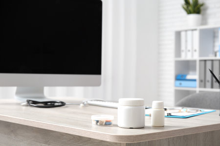 Pill bottles on doctor's desk in medical office, closeupの写真素材