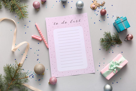 Blank to-do list with gifts and Christmas decor on light background