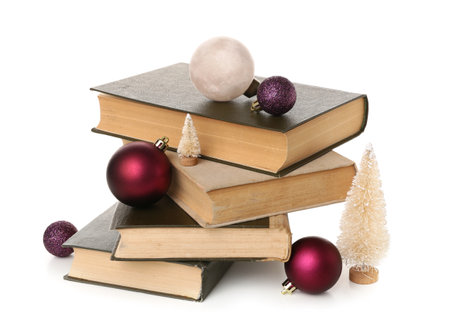 Stack of old books with beautiful Christmas decorations on white backgroundの写真素材
