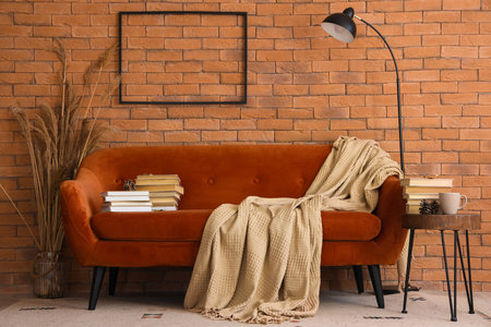 Interior of living room with red sofa, table and booksの写真素材