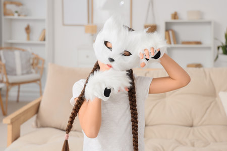 Quadrober girl in cat mask at homeの写真素材
