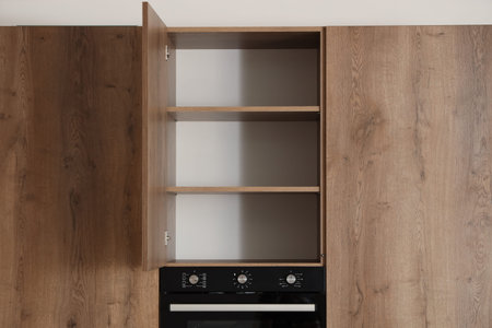 Open cupboard with shelves in modern kitchen interior