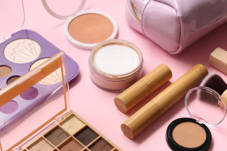 Cosmetic bag and set of cosmetics and accessories on pink background, closeupの写真素材