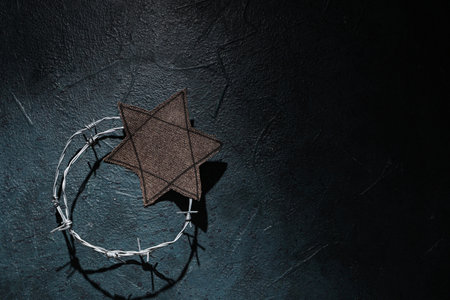 Jewish badge with barbed wire on grunge blue background. International Holocaust Remembrance Dayの写真素材