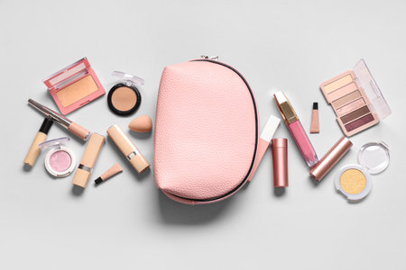 Cosmetic bag with different makeup products on gray backgroundの写真素材