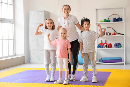 Cute little children with trainer in gymの写真素材