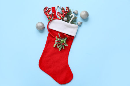 Christmas sock with reindeer horns and decorations on blue background. Top viewの写真素材