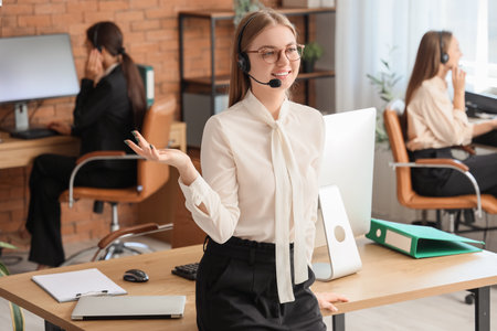 Female technical support agent smiling in officeの写真素材
