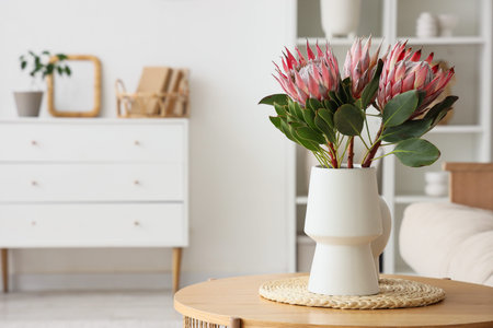 Beautiful protea flowers on coffee table in living roomの写真素材