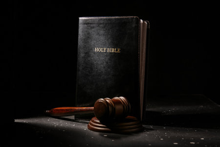 Holy Bible with judge's gavel on dark backgroundの写真素材