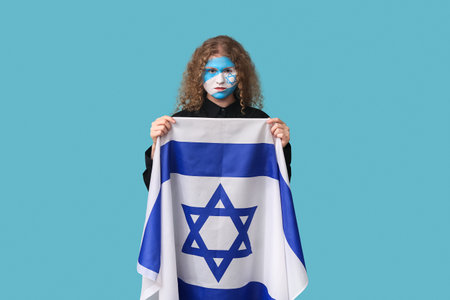 Young woman with painted face and flag of Israel on blue background. International Holocaust Remembrance Dayの写真素材