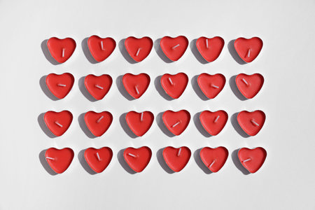 Candles in the shape of heart on gray background. Valentine's Day celebration