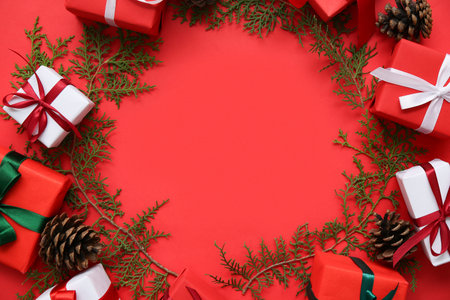 Frame made of Christmas decorations on red background. Top view