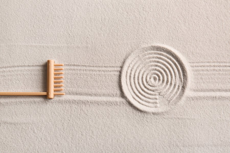 Small rake on light sand with lines. Zen conceptの写真素材