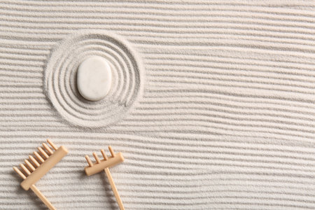Stone and small rakes on light sand with lines. Zen conceptの写真素材