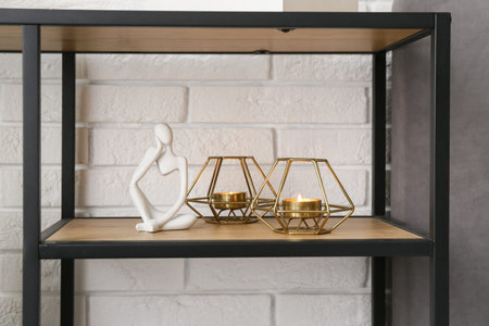 Burning candles and human figure on shelving unit in bedroom. Closeupの写真素材