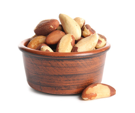Bowl with tasty Brazil nuts on white backgroundの写真素材