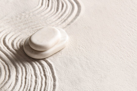 Stack of stones on light sand with lines. Zen conceptの写真素材