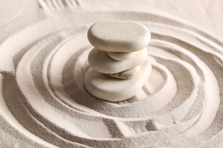 Stack of stones on light sand with lines. Zen conceptの写真素材