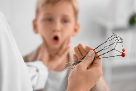 Female speech therapist with logopedic probes and little boy in office, closeupの写真素材