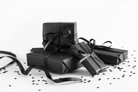 Many black gift boxes on gray background