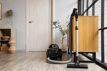 Vacuum cleaner near commode in roomの写真素材