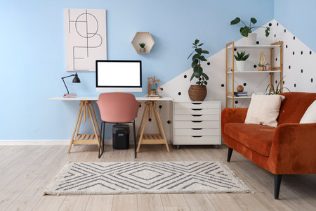 Interior of stylish living room with workplace, sofa and shelf unitの写真素材