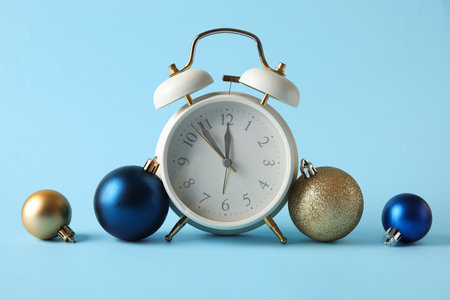 Composition with alarm clock and Christmas balls on blue backgroundの写真素材