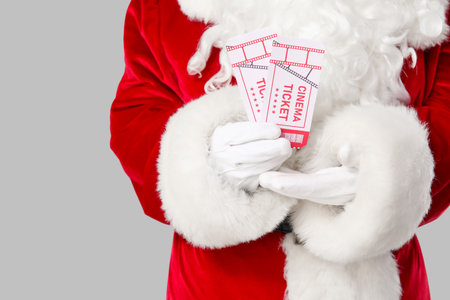 Santa Claus with cinema tickets on gray background. Closeupの写真素材