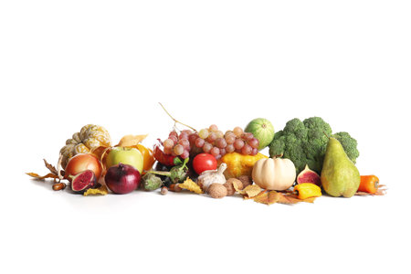 Different fresh vegetables with fruits and walnuts on white background. Harvest festivalの写真素材
