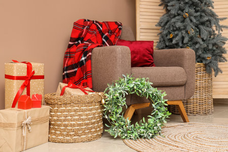 Comfortable armchair with Christmas mistletoe wreath in decorated living roomの写真素材