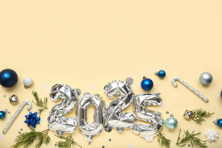 Figure 2025 made of foil balloons with Christmas balls, candy canes and coniferous branches on...
