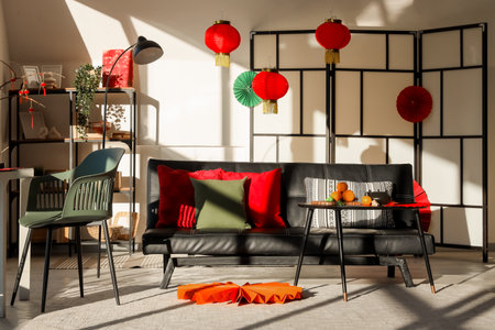 Interior of light living room with sofa, folding screen and decor for Chinese New Year celebrationの写真素材