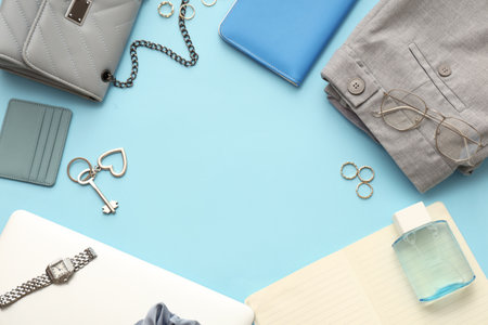 Frame made of female accessories, clothes and laptop on color backgroundの写真素材