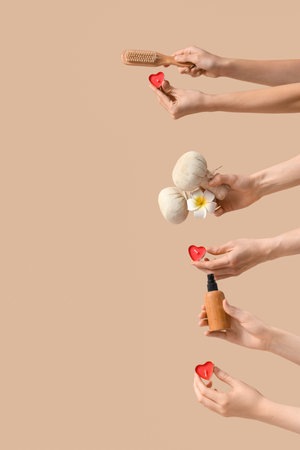 Female hands with candles and spa supplies on beige background. Valentine's Day celebrationの写真素材