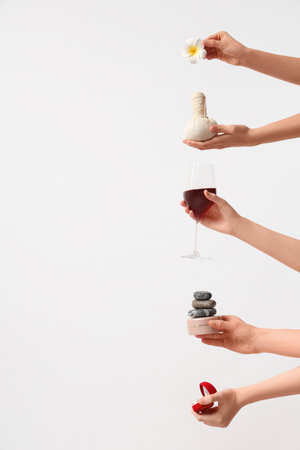 Female hands with spa supplies, wine and engagement ring on white background. Valentine's Day celebrationの写真素材