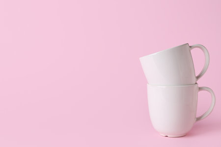 White ceramic empty mugs on pink backgroundの写真素材