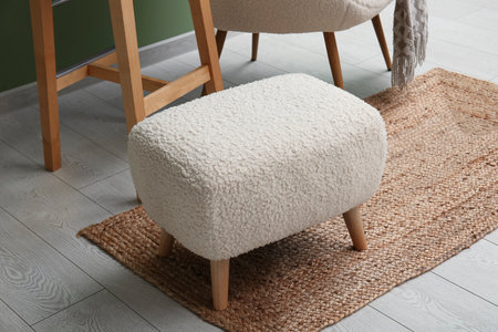 White pouf with rug on floor in roomの写真素材