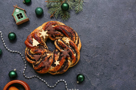 Tasty Christmas pastry wreath and beautiful decorations on dark backgroundの写真素材
