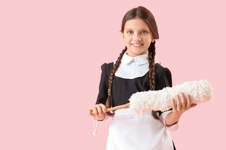 Cute chambermaid with pp-duster on pink backgroundの写真素材