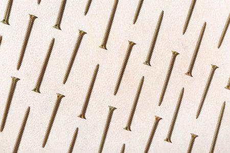 Many screws on white grunge backgroundの写真素材