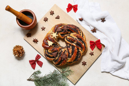 Wooden board with tasty Christmas pastry wreath, fir tree branches, mortar, decor and cookies on white backgroundの写真素材