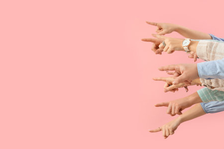 Many hands pointing at something on pink backgroundの写真素材