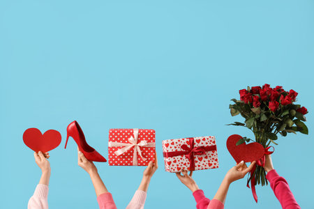 Female hands with hearts, gift boxes, high heel and roses on blue background. Valentine's Day celebrationの写真素材