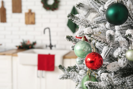 Christmas tree with balls in light kitchen, closeupの写真素材