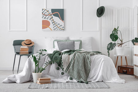 Interior of light bedroom with chair, painting and folding screenの写真素材