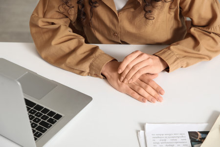 Young businesswoman suffering from pain in hand at office, closeupの写真素材